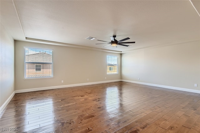 empty room featuring hardwood / wood-style flooring and ceiling fan