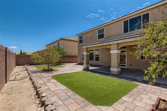 rear view of property featuring a patio