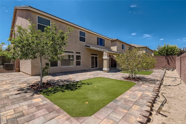 back of house with a patio