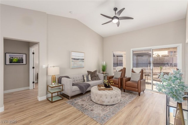 living room featuring lofted ceiling, light hardwood / wood-style floors, and ceiling fan