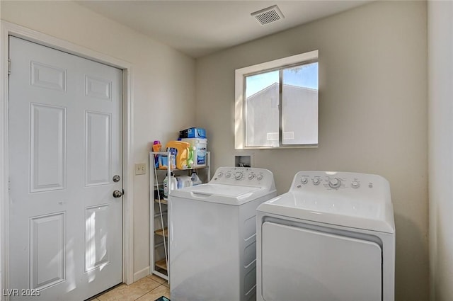 washroom featuring light tile patterned flooring and separate washer and dryer