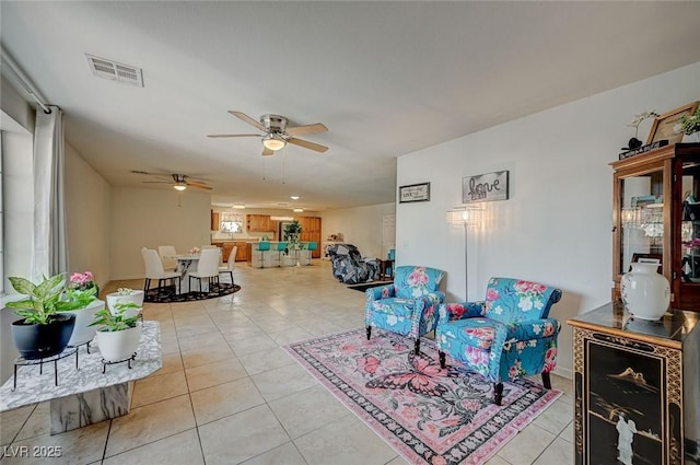 tiled living room with ceiling fan