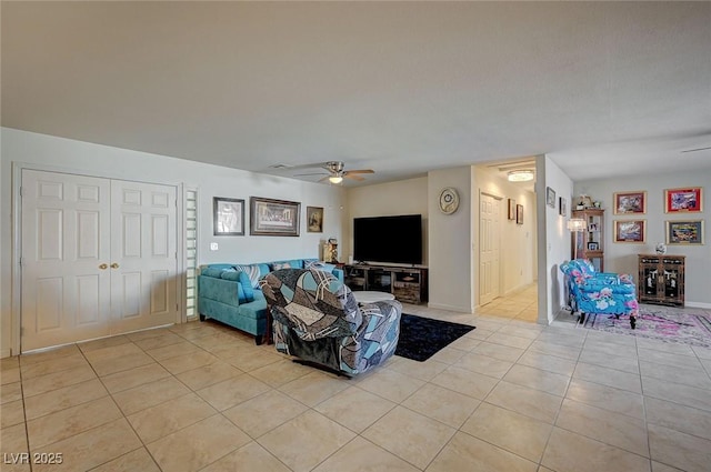 tiled living room featuring ceiling fan