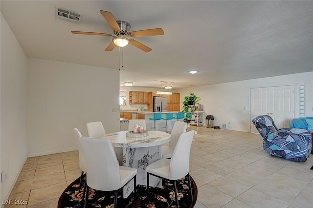 dining area featuring light tile patterned floors and ceiling fan