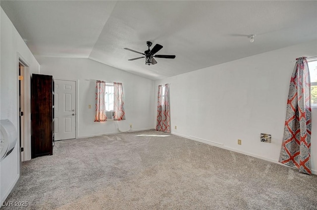 unfurnished bedroom with vaulted ceiling, light colored carpet, ceiling fan, and cooling unit