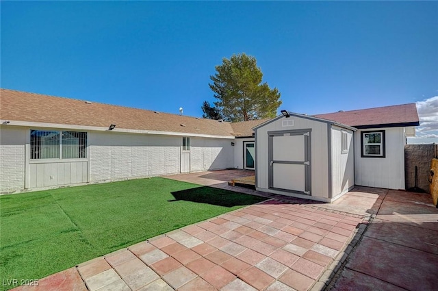 exterior space with a storage shed, a patio area, and a lawn