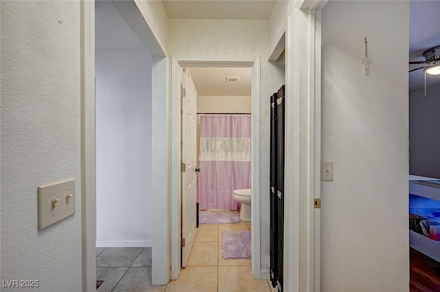 corridor featuring light tile patterned floors