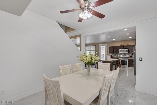 dining room featuring sink and ceiling fan