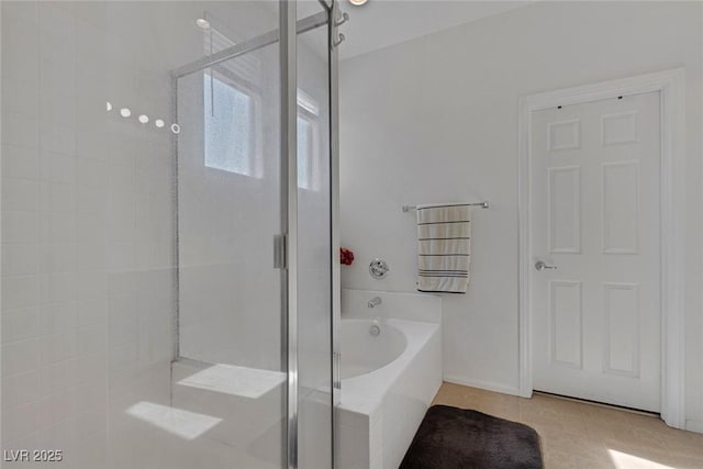 bathroom featuring tile patterned flooring and shower with separate bathtub