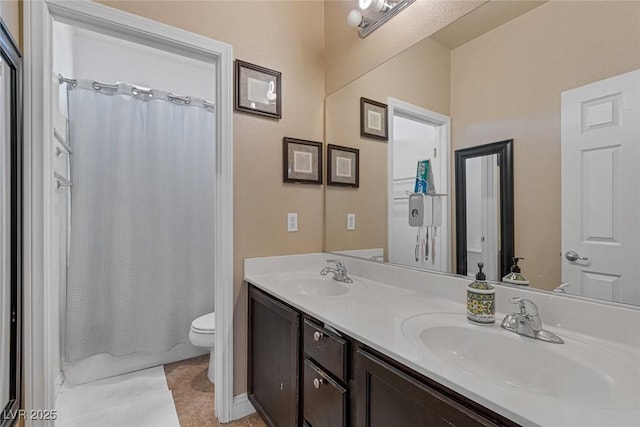 bathroom with tile patterned flooring, vanity, and toilet