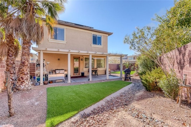 rear view of house with a patio, an outdoor hangout area, and a lawn