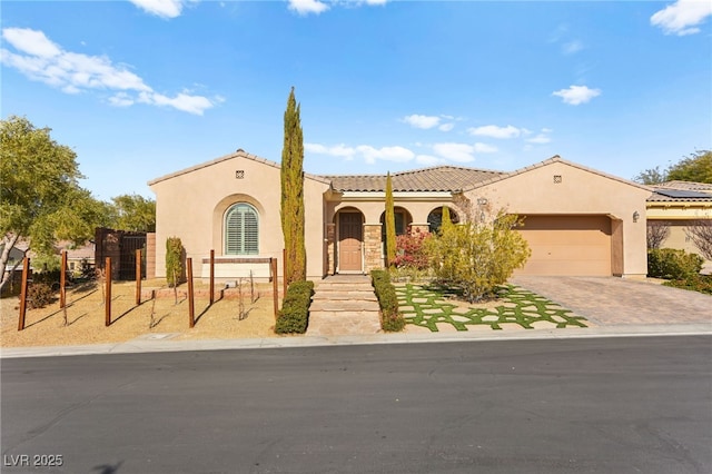 mediterranean / spanish home with a garage