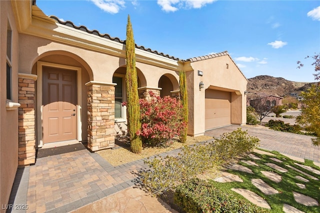 mediterranean / spanish-style home featuring a garage and a mountain view