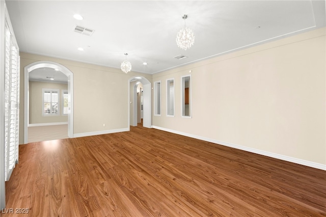 unfurnished room with wood-type flooring and ornamental molding