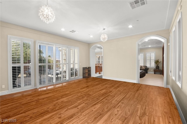 interior space featuring a notable chandelier and light hardwood / wood-style flooring