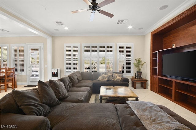 tiled living room with ornamental molding and ceiling fan