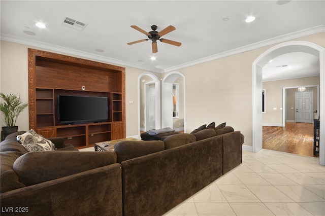 living room with crown molding and ceiling fan