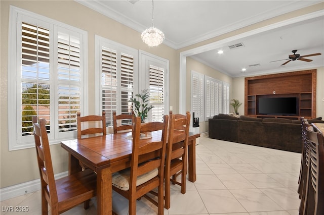 dining area with ceiling fan with notable chandelier and ornamental molding