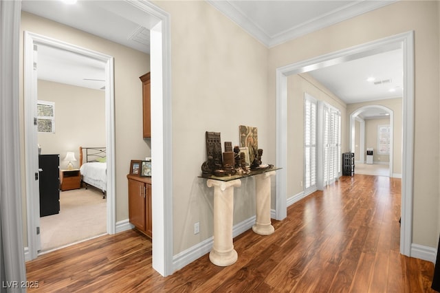 corridor featuring crown molding and dark hardwood / wood-style flooring