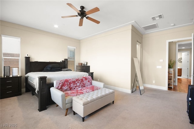 bedroom with ceiling fan and light colored carpet