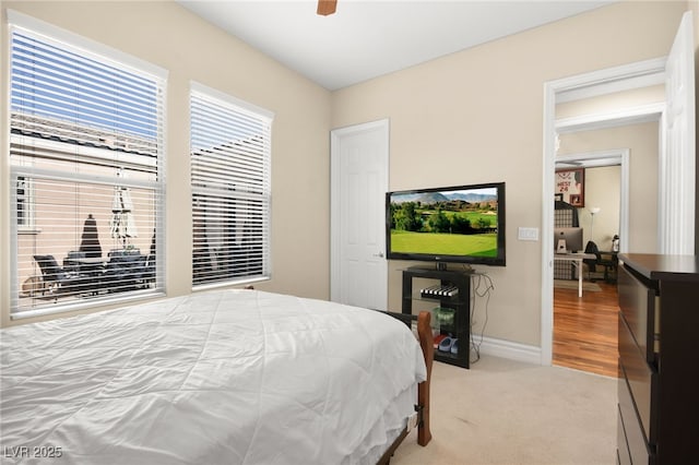 bedroom with ceiling fan and light colored carpet