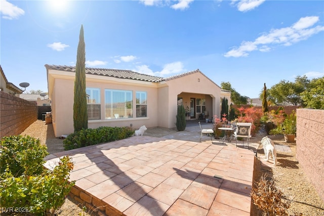 back of property featuring a patio