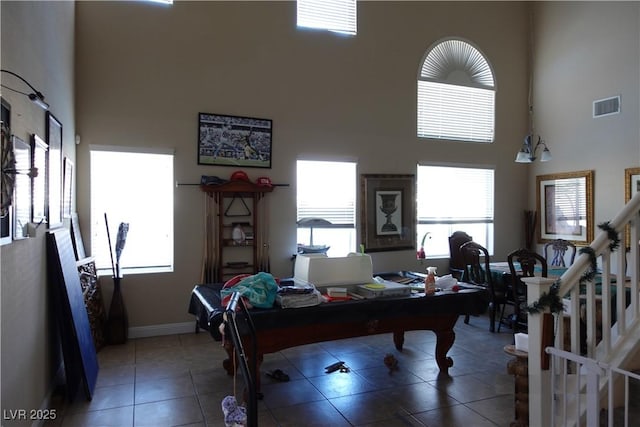 tiled office space featuring a towering ceiling and billiards