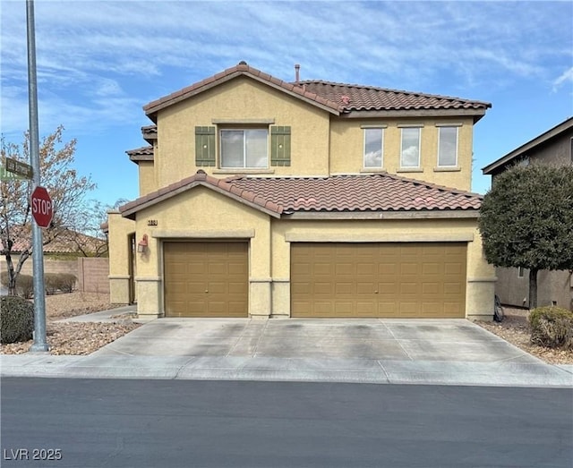 mediterranean / spanish-style home with a garage