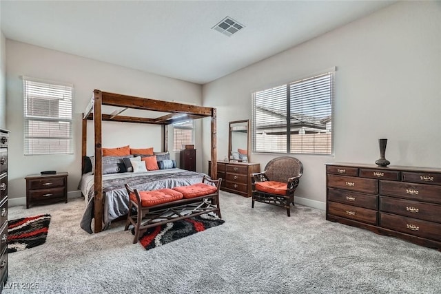 carpeted bedroom with multiple windows