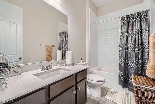 full bathroom featuring shower / tub combo with curtain, vanity, hardwood / wood-style floors, and toilet