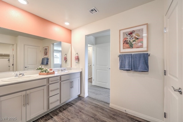 bathroom featuring hardwood / wood-style flooring and vanity