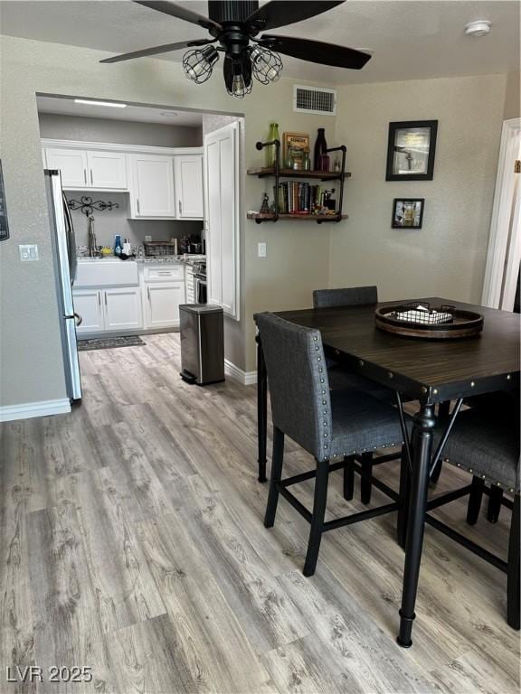 dining area featuring light hardwood / wood-style flooring and ceiling fan