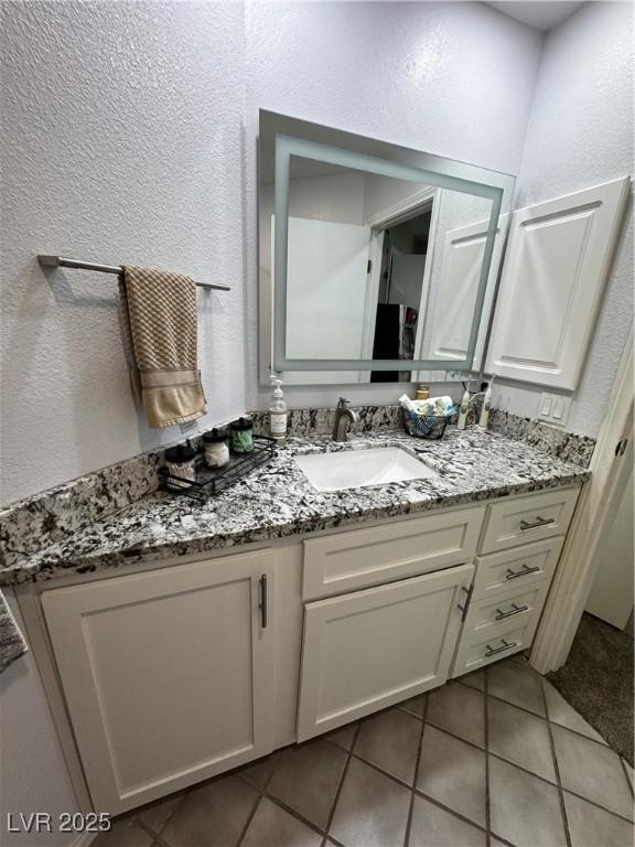 bathroom featuring tile patterned floors and vanity