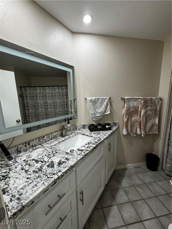 bathroom featuring tile patterned flooring and vanity