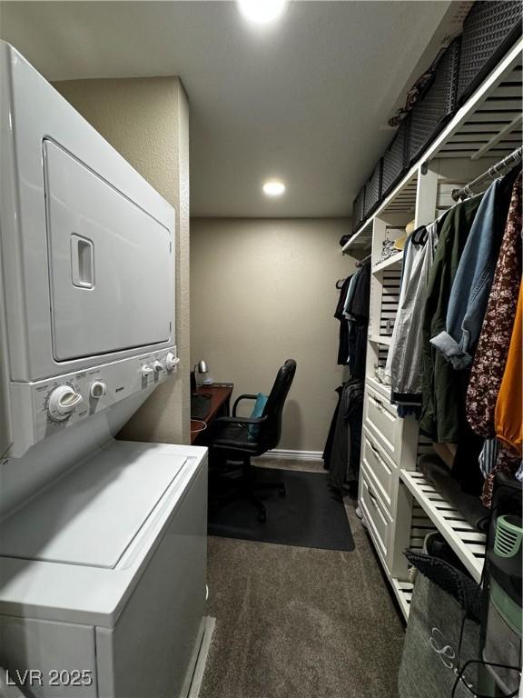 laundry area with dark colored carpet and stacked washing maching and dryer