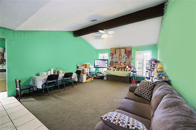 interior space with lofted ceiling with beams, ceiling fan, carpet floors, and a textured ceiling