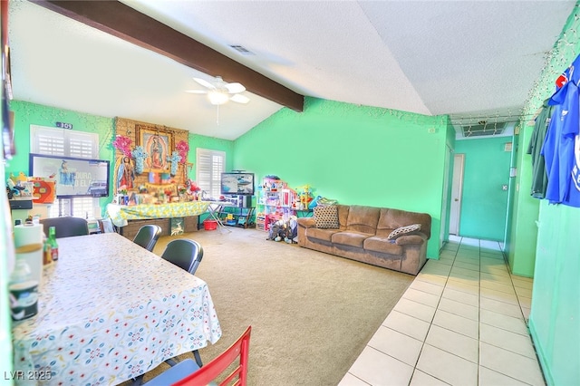 carpeted living room with ceiling fan, a textured ceiling, and vaulted ceiling with beams