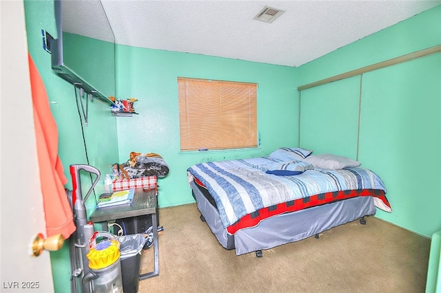 carpeted bedroom featuring a closet and a textured ceiling