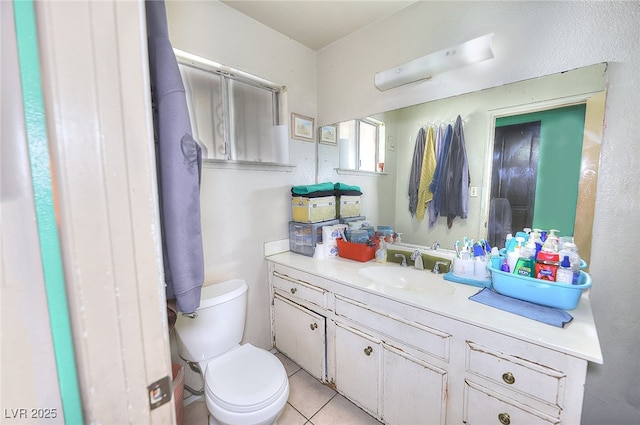 bathroom with vanity, tile patterned floors, and toilet