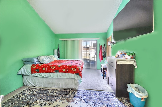 bedroom with lofted ceiling and carpet flooring