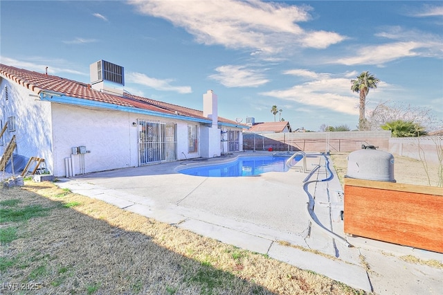 view of swimming pool with a patio area and central air condition unit