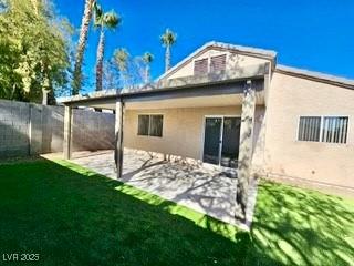 back of property featuring a yard and a patio