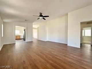 unfurnished living room with ceiling fan and dark hardwood / wood-style floors