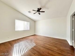 unfurnished room featuring ceiling fan, dark hardwood / wood-style floors, and vaulted ceiling