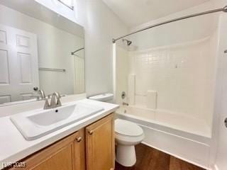 full bathroom with vanity, wood-type flooring, shower / bathing tub combination, and toilet