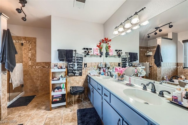 bathroom with vanity, separate shower and tub, tile patterned flooring, and tile walls