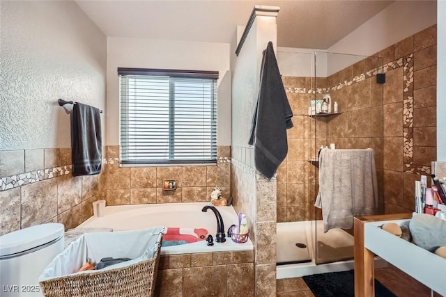 bathroom with toilet and shower with separate bathtub