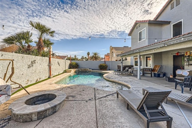 view of swimming pool featuring a patio and an outdoor fire pit