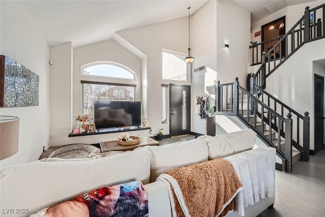 living room with high vaulted ceiling