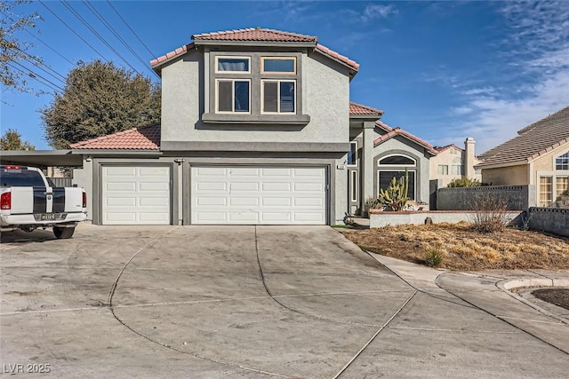 mediterranean / spanish house featuring a garage and a carport